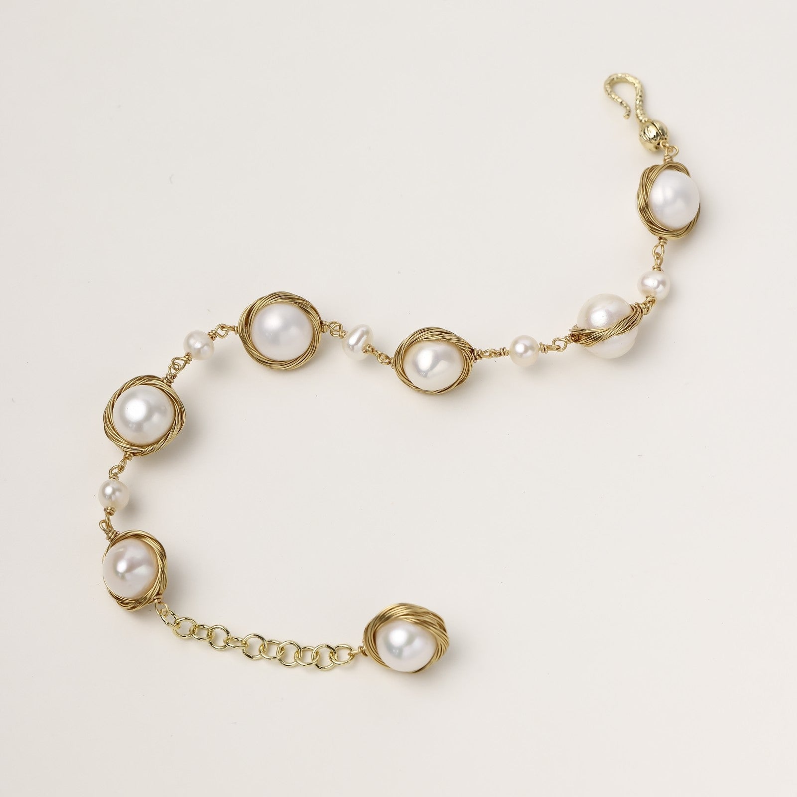 14K gold plated bracelet featuring wire-wrapped freshwater pearls in nest-like settings with adjustable chain closure