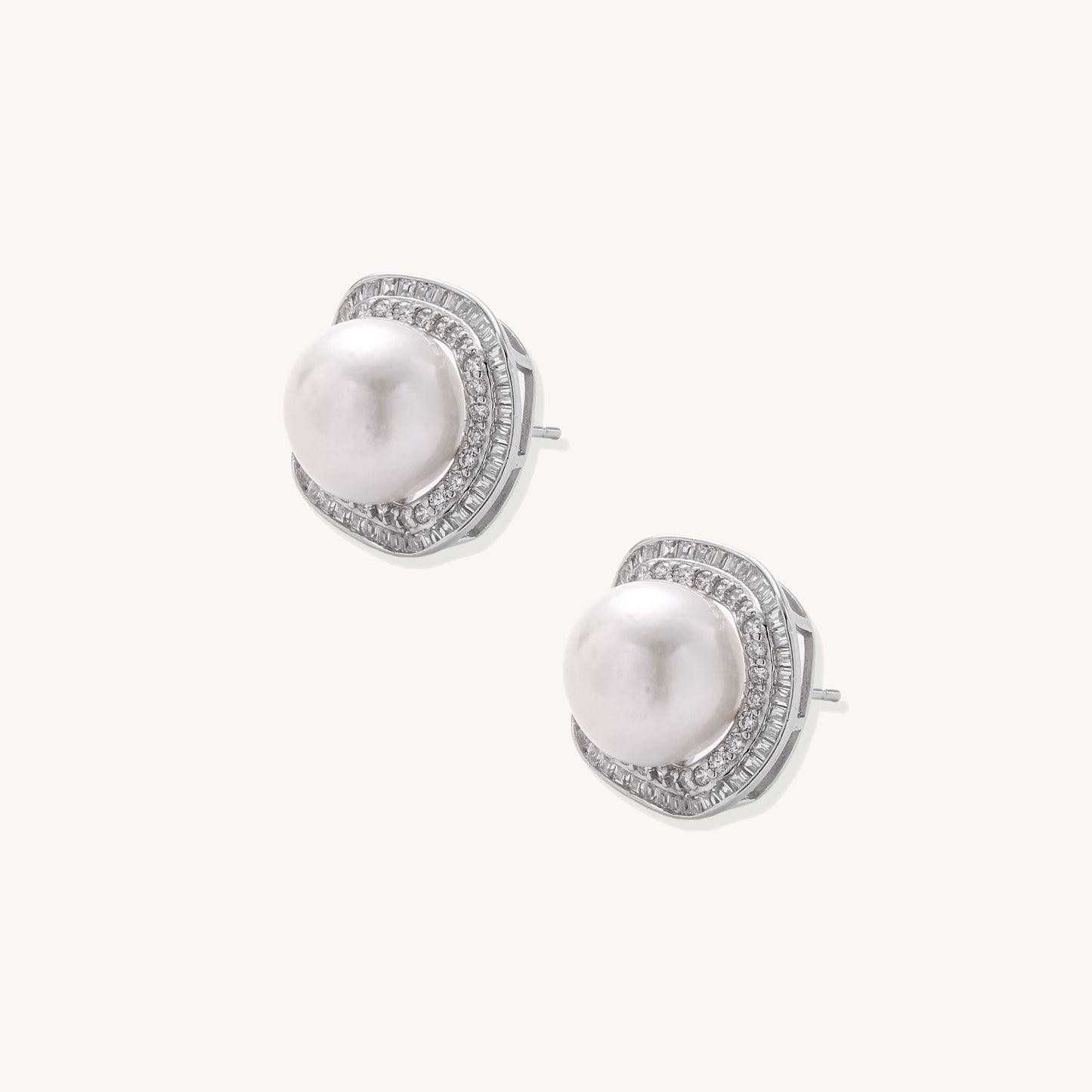Sterling silver stud earrings with round freshwater pearls surrounded by sparkling crystal halos on white background.