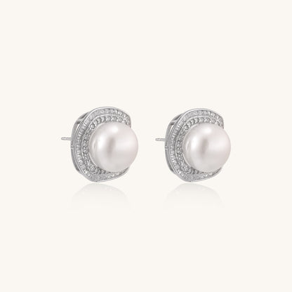 Sterling silver stud earrings with round freshwater pearls surrounded by sparkling crystal halos on white background.