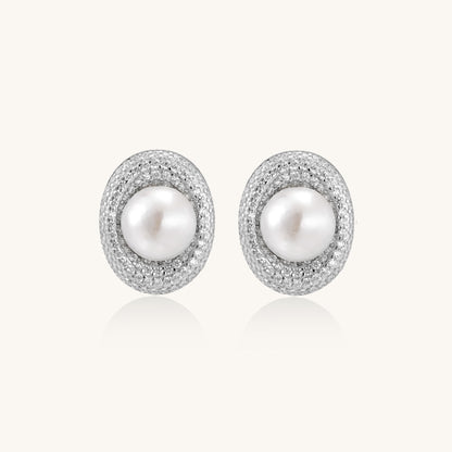 Sterling silver stud earrings with freshwater pearls surrounded by sparkling pavé crystals on white background.