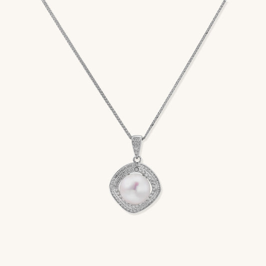 Sterling silver necklace with geometric halo setting surrounding a 10mm freshwater pearl on white background.