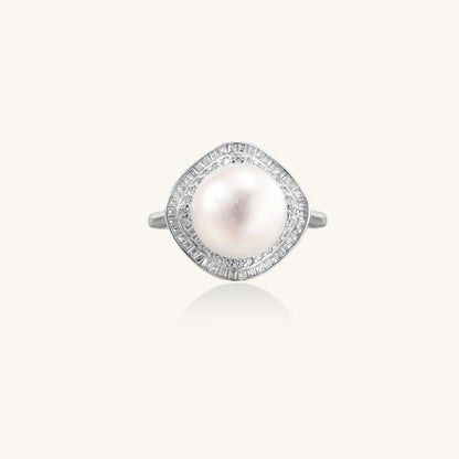 Sterling silver ring with 11mm freshwater pearl surrounded by double diamond halo on white background.