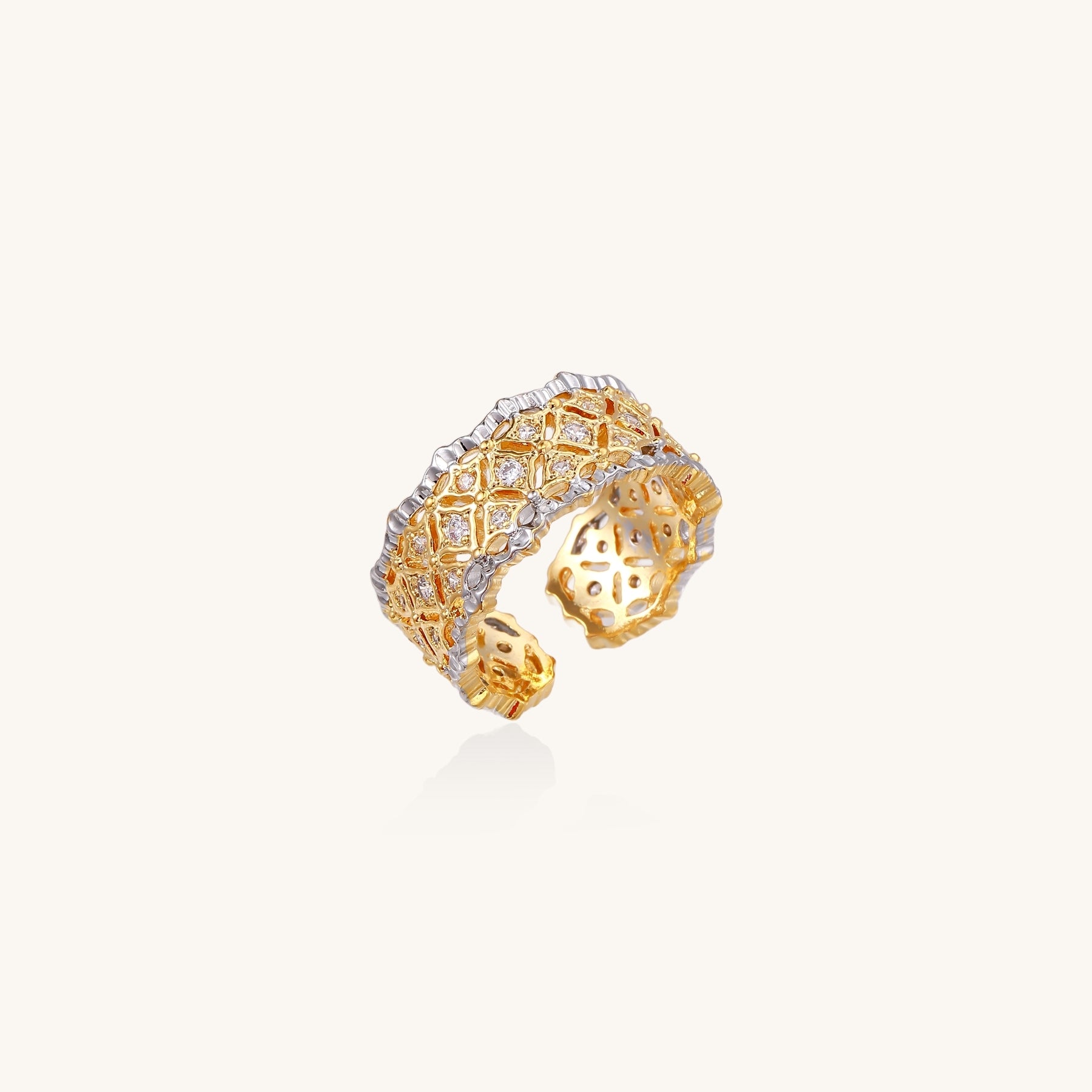 Bold geometric ring with lattice pattern in gold-plated brass featuring multiple tiers of sparkling zirconia stones
