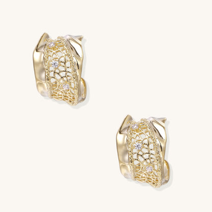 Close-up of gold-plated brass hoop earrings with geometric lattice pattern and sparkling zirconia stones