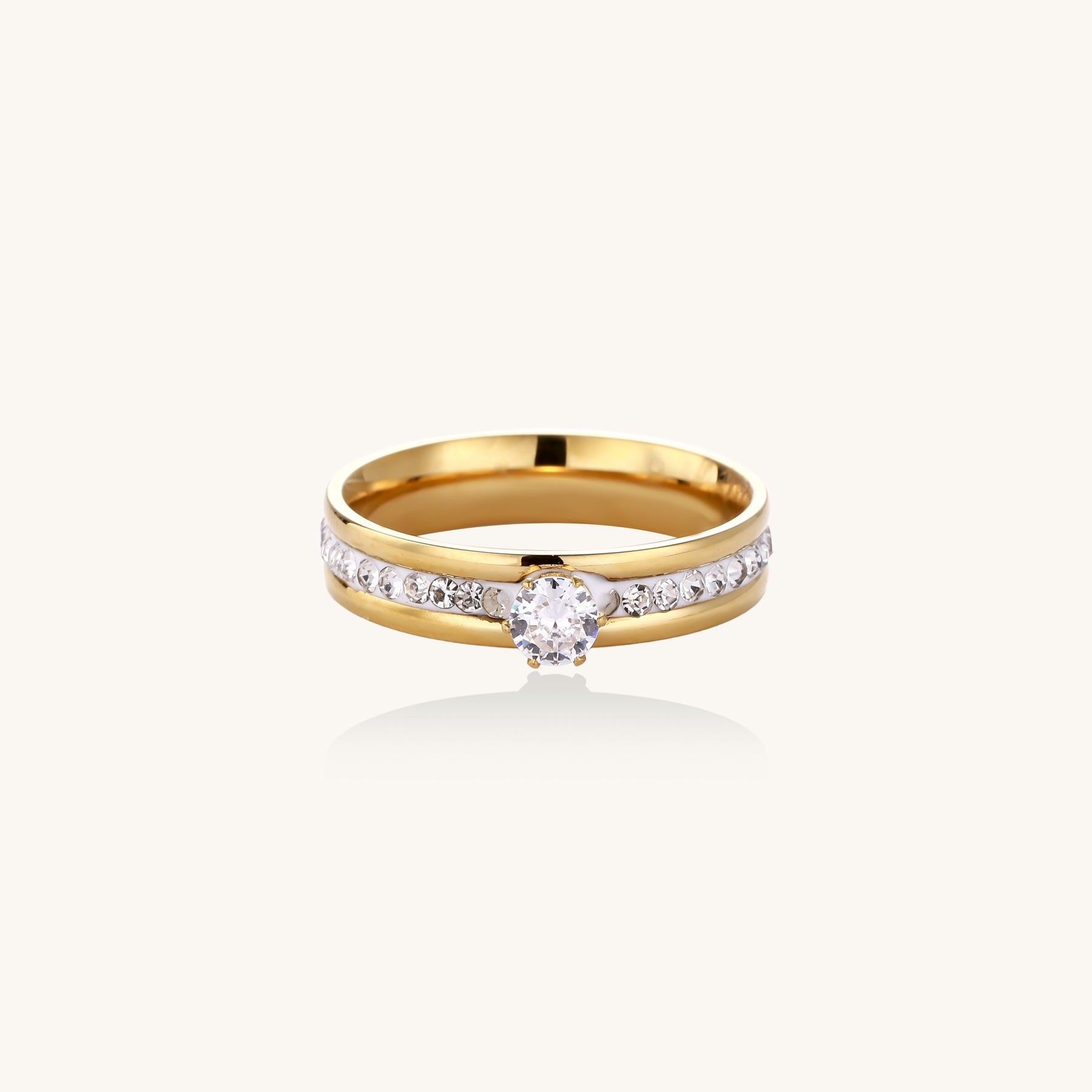 14K gold plated ring with center rhinestone and accent stones along the band on white background.