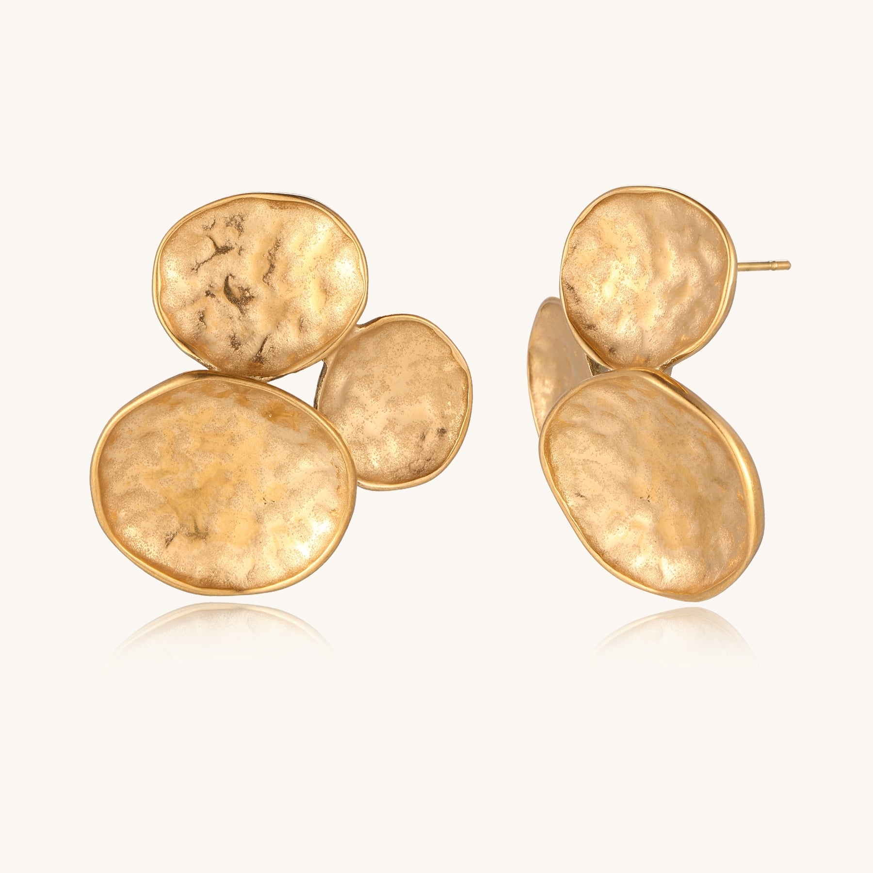 Sculptural gold-plated stainless steel earrings with three hammered oval shapes arranged in artistic cluster formation
