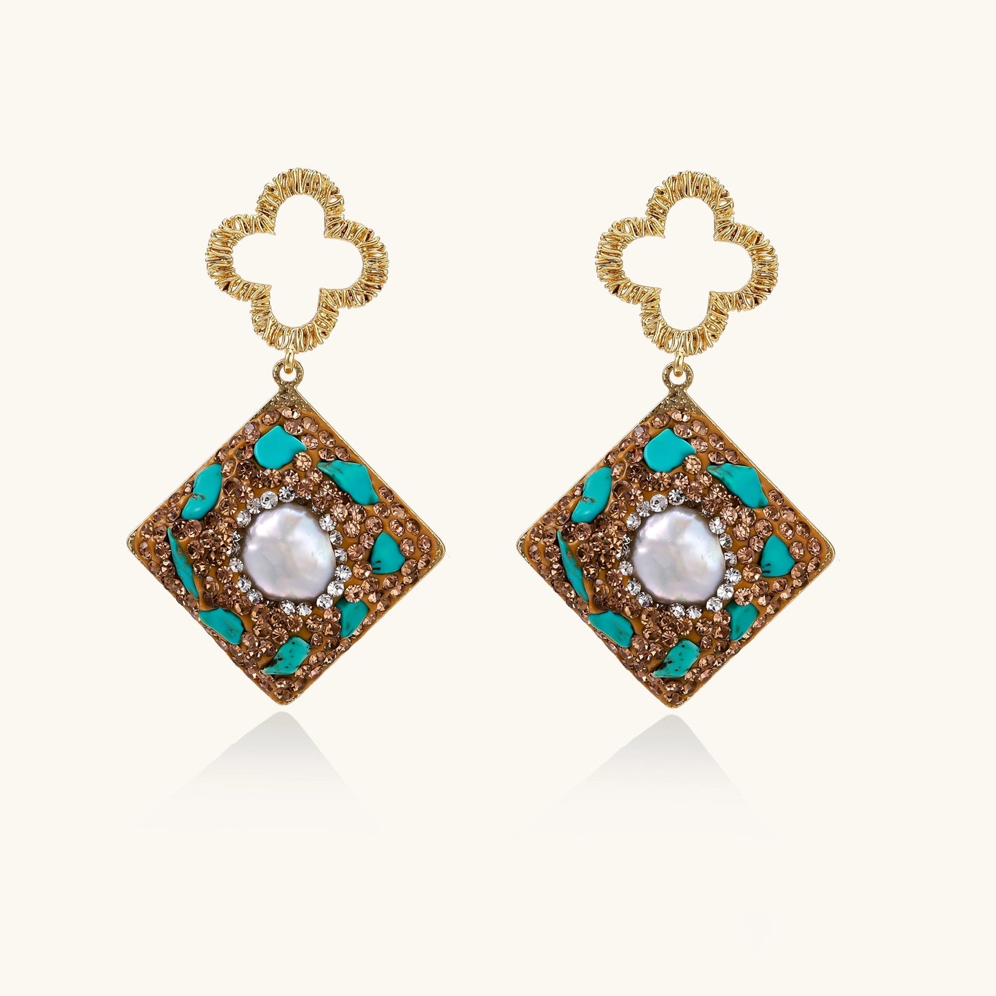 Gold quatrefoil stud earrings with ornate square pendants featuring turquoise stones and freshwater pearls
