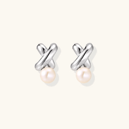 Sterling silver twisted stud earrings with round freshwater pearls on cream background, showing polished finish