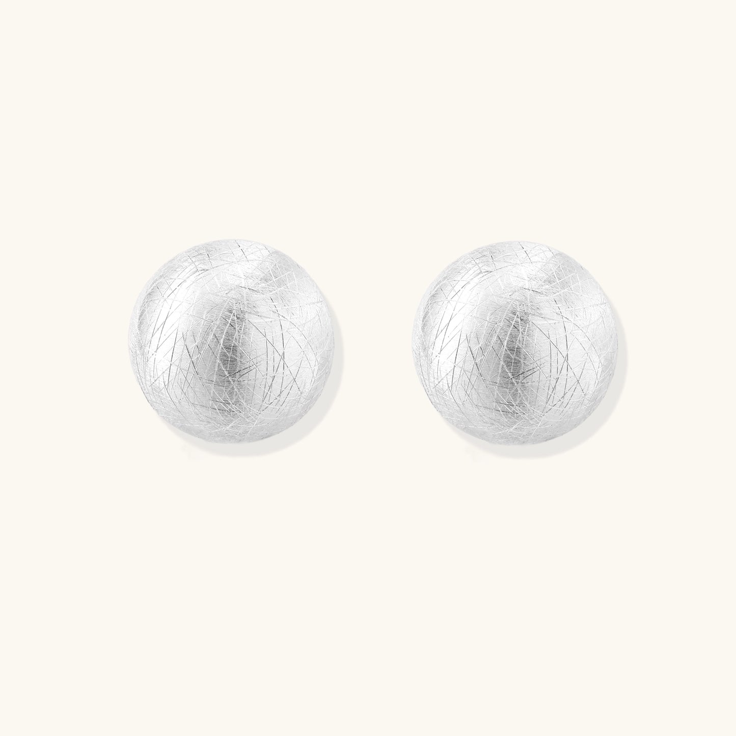 Brushed sterling silver dome-shaped stud earrings with textured surface and secure lever-back closure on white background.