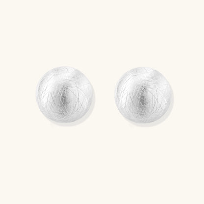Brushed sterling silver dome-shaped stud earrings with textured surface and secure lever-back closure on white background.