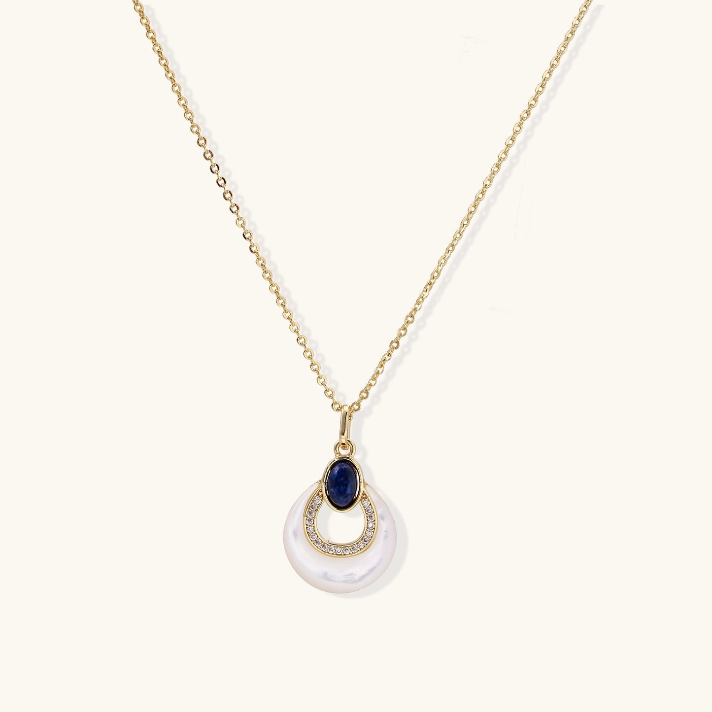 Layered pendant necklace with deep blue lapis lazuli stone, crystals, and white mother of pearl on 18k gold plated chain