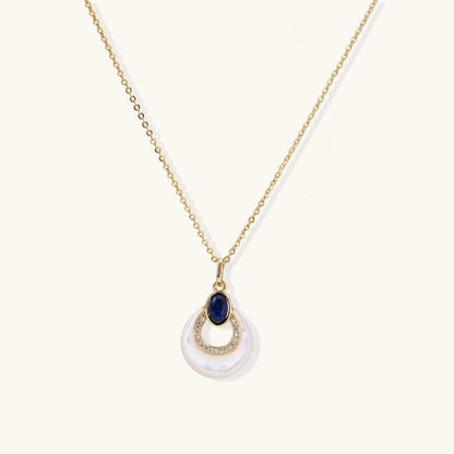 Layered pendant necklace with deep blue lapis lazuli stone, crystals, and white mother of pearl on 18k gold plated chain