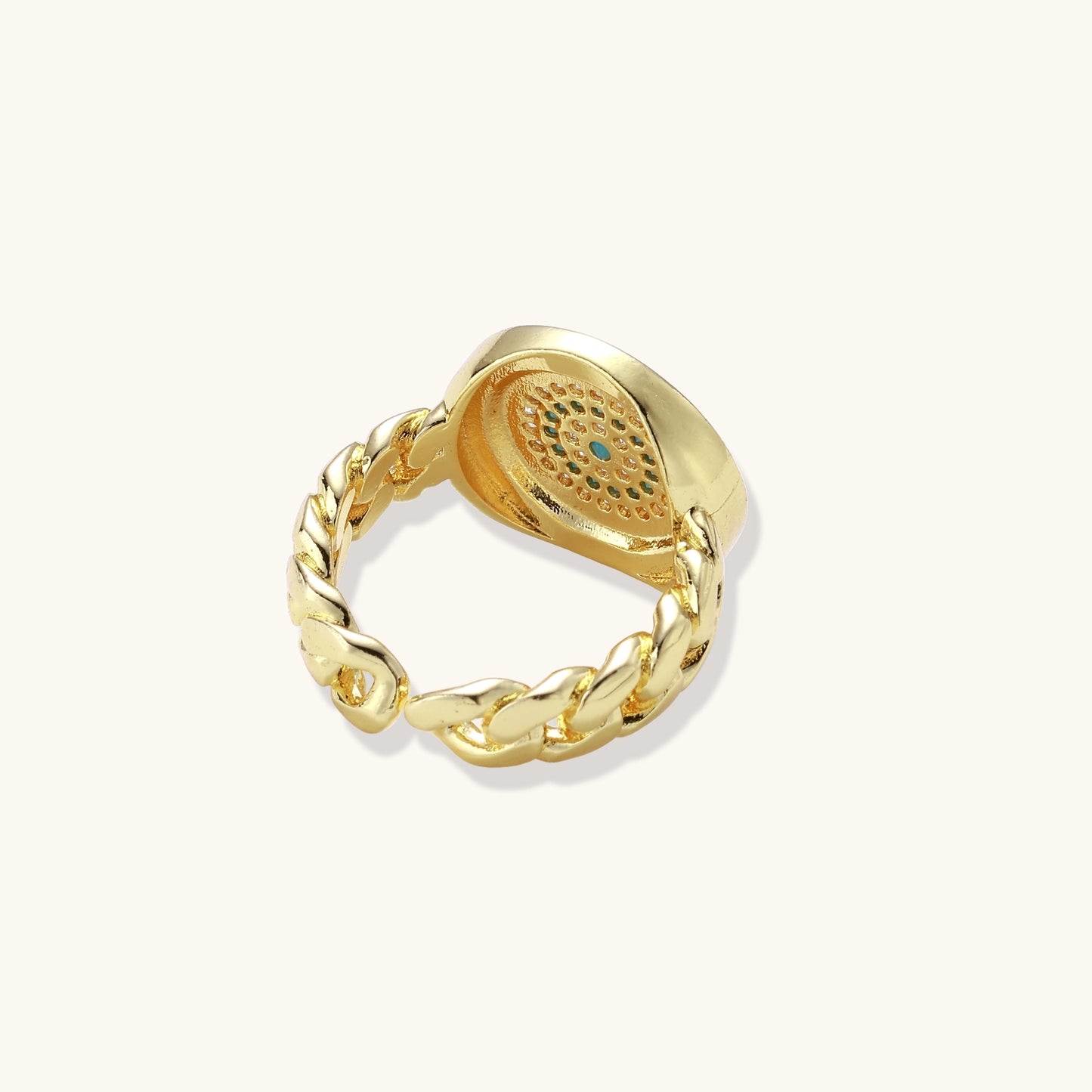 Gold-plated brass ring with Greek key border, evil eye center, and turquoise cubic zirconia stones in chunky chain band style.