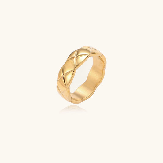 18K gold plated stainless steel ring with geometric twisted band design on neutral background
