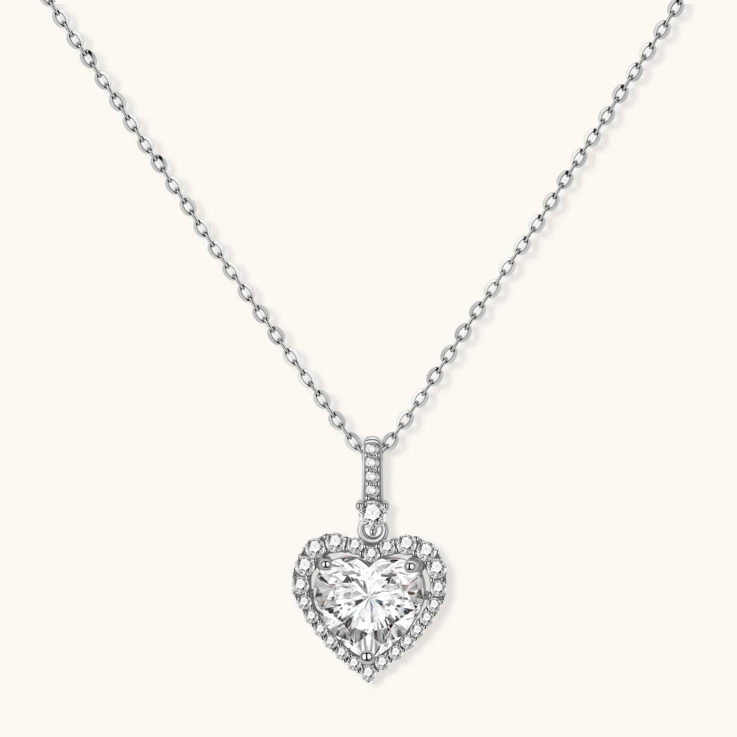 Sterling silver heart pendant necklace with brilliant moissanite center stone and halo setting on delicate chain