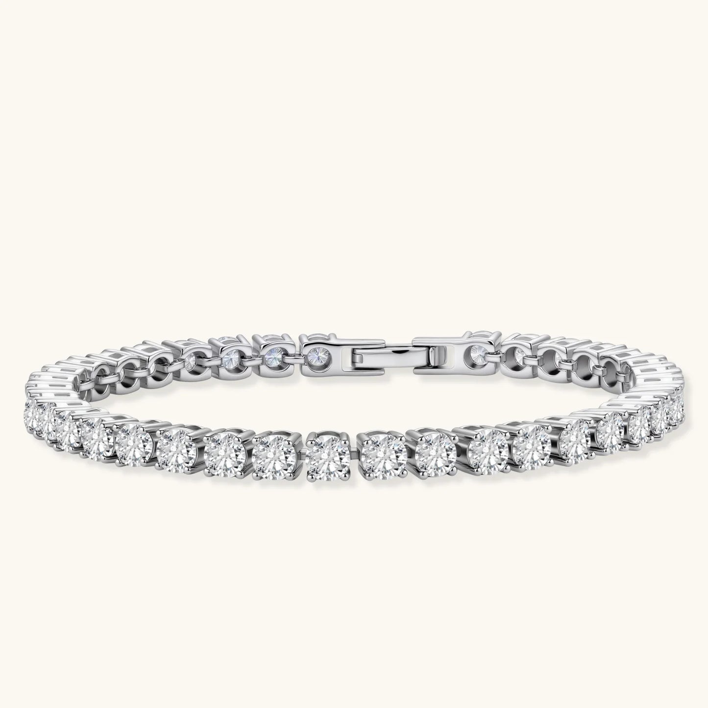 Sterling silver tennis bracelet with continuous row of brilliant moissanite stones and secure clasp closure on cream background.