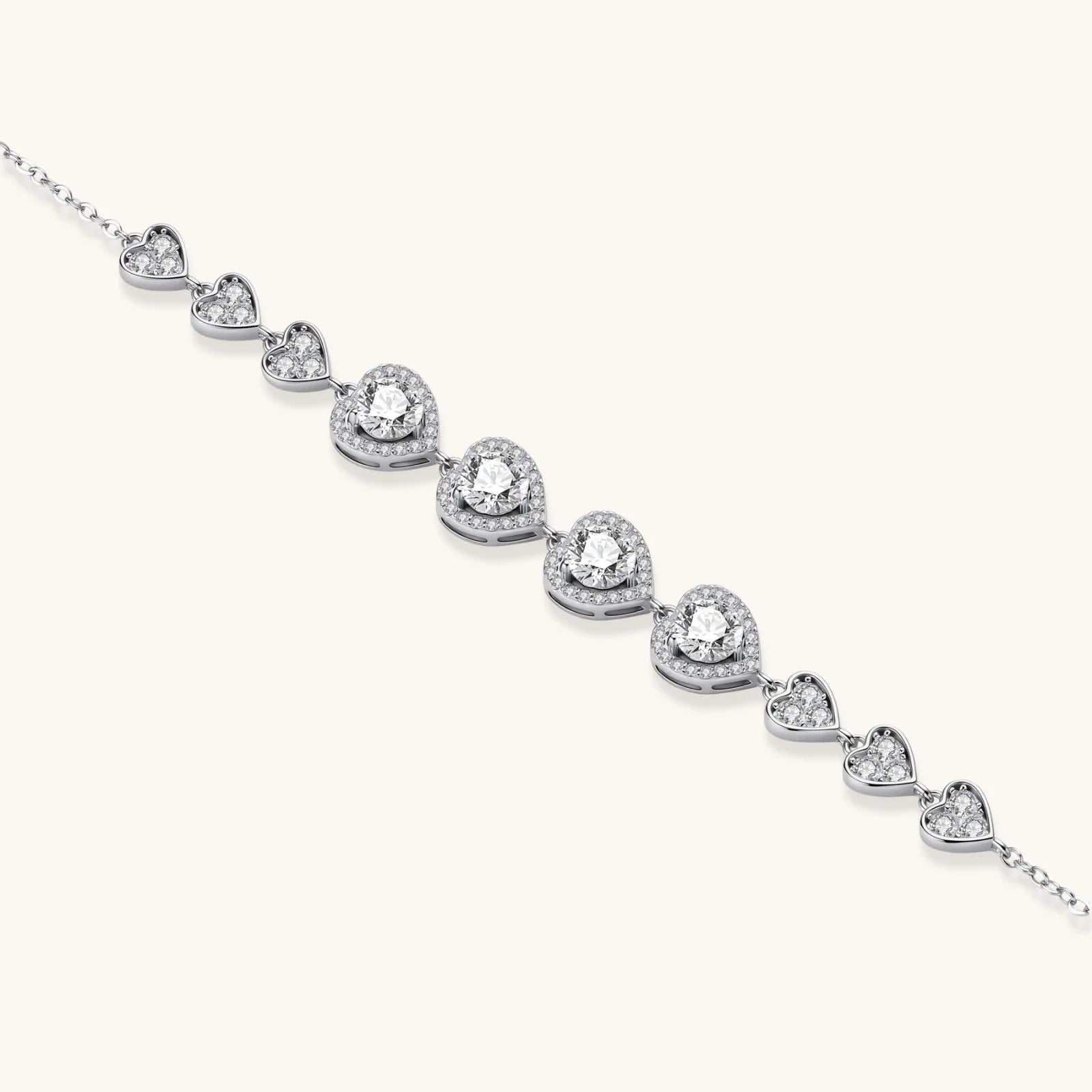 Complete jewelry set with heart-shaped sterling silver pieces featuring brilliant moissanite stones on white background.