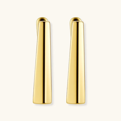 Sleek 14K gold-plated sterling silver huggie earrings with polished finish and geometric elongated design on white background.