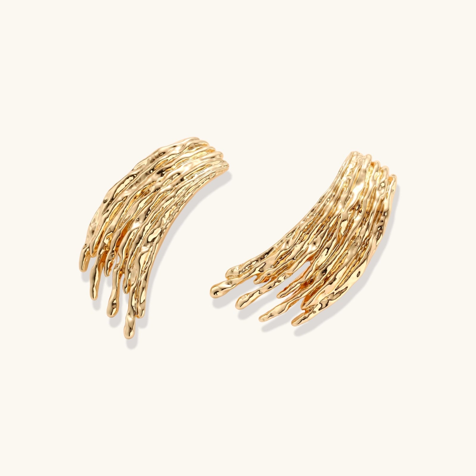 Gold-toned cascade jewelry set with flowing textured strands, featuring drop earrings and matching pendant necklace