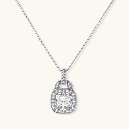 Sterling silver cushion halo pendant necklace featuring 2ct moissanite center stone with delicate box chain on neutral background.