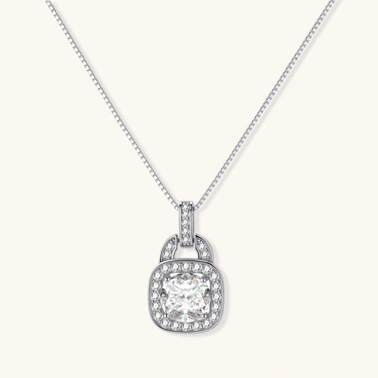 Sterling silver cushion halo pendant necklace featuring 2ct moissanite center stone with delicate box chain on neutral background.