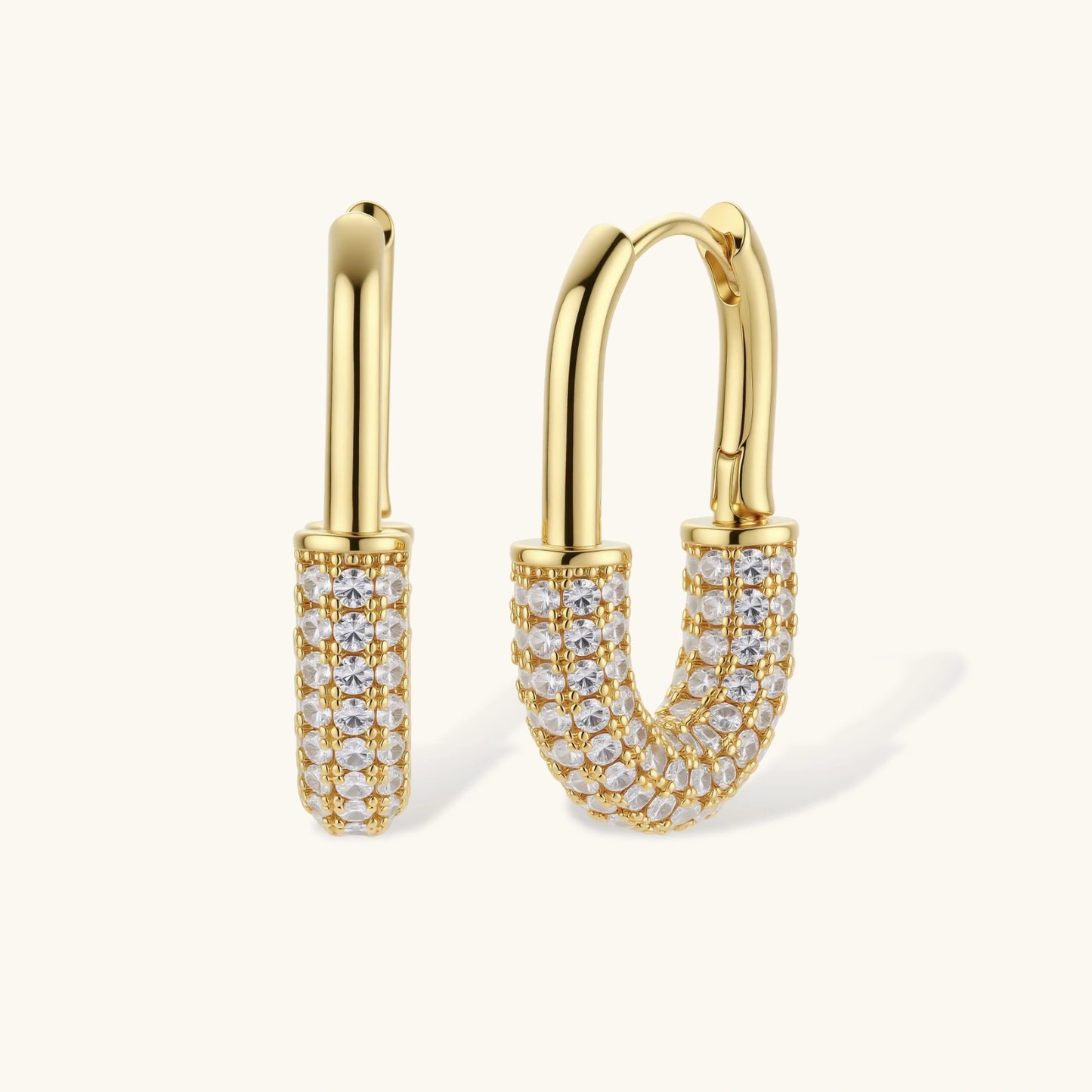 Gold-plated huggie hoop earrings with pavé zirconia stones covering the bottom curve, shown in open and closed positions.