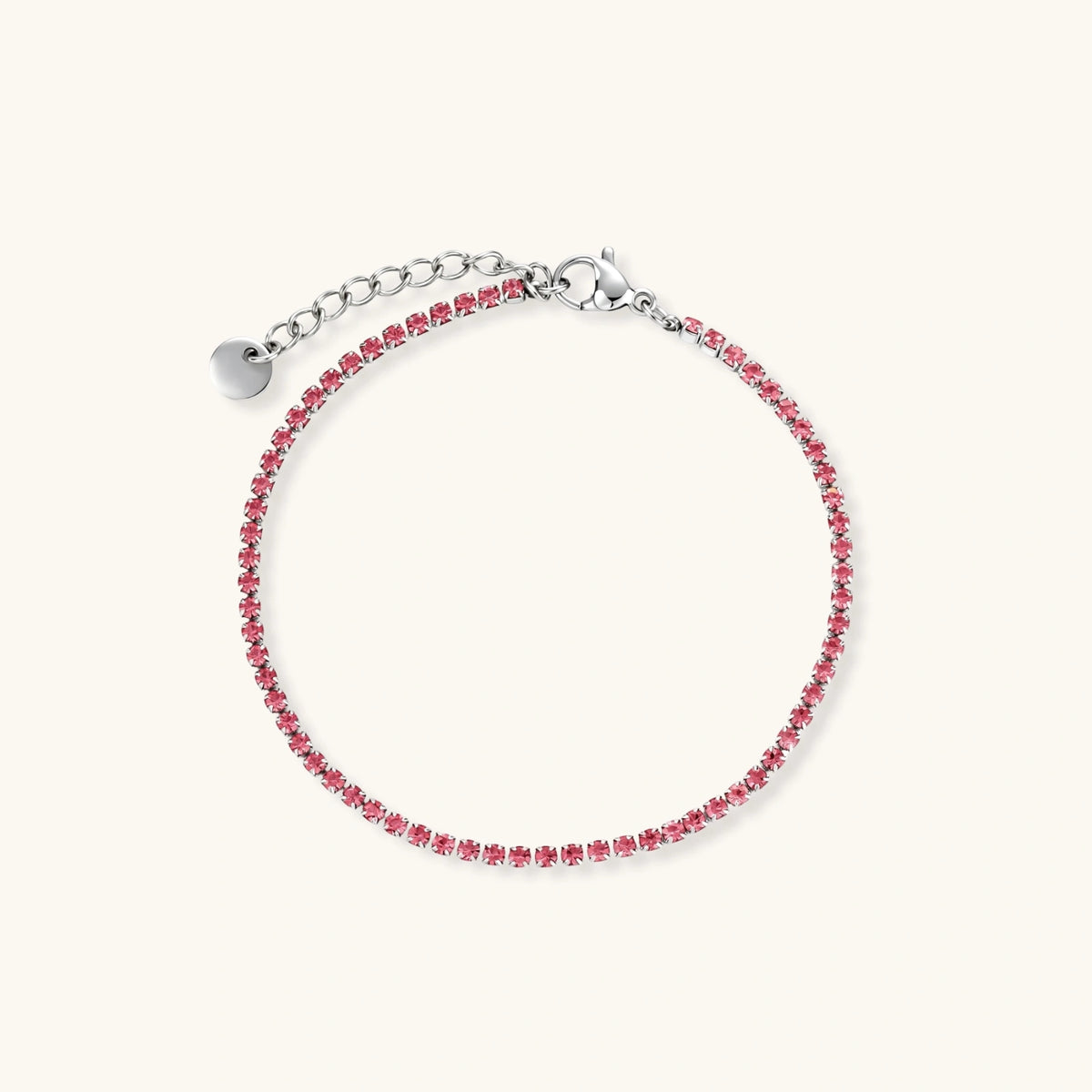 Pink zircon tennis bracelet with silver-tone stainless steel setting and lobster clasp extender chain, flat lay.