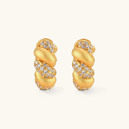 Pair of 18K gold-plated 925 silver huggie hoops with twisted braid texture and pavé cubic zirconia detailing, 15mm.